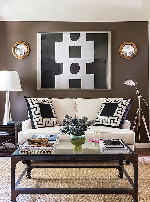 Two oversize square pillows are the perfect match for a petite sofa, serving as simple but statement-making bookends to the vignette. Photo by Lesley Unruh.
