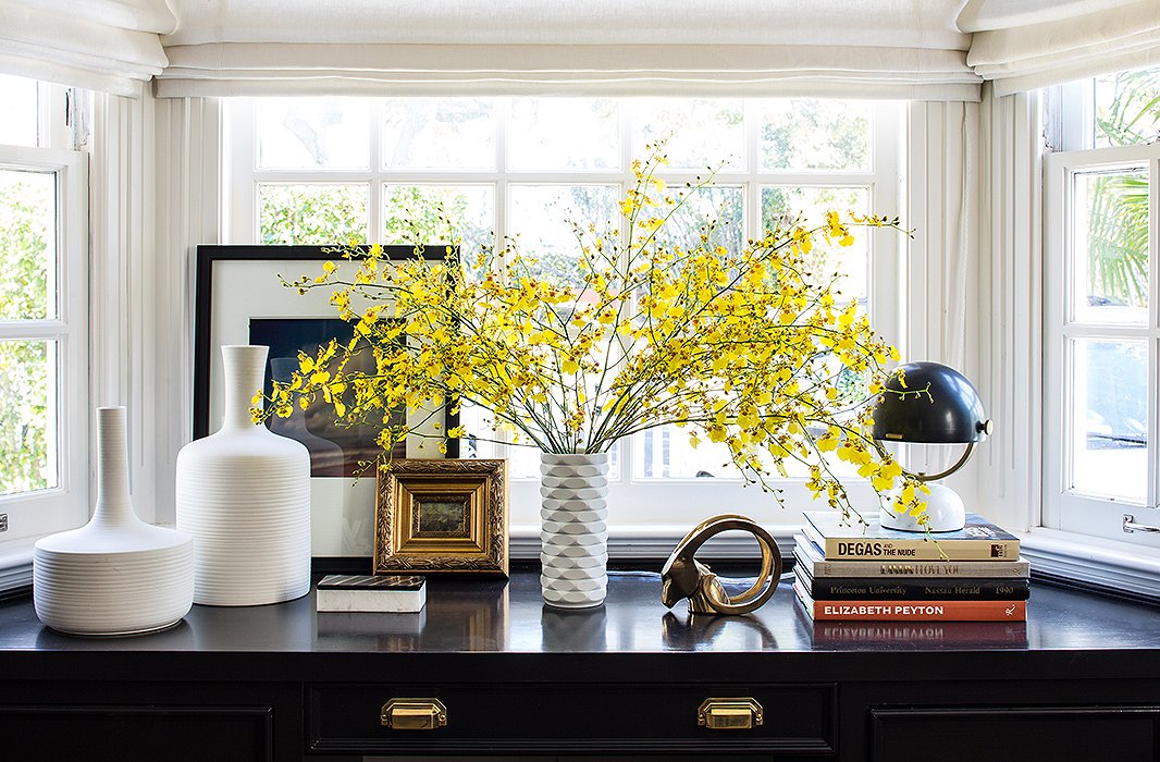 The space formerly had “chinoiserie Roman shades and a chandelier, which all felt a little heavy,” Alex says. In came new shades in a natural white linen, which keep the option for privacy but let in more light.
