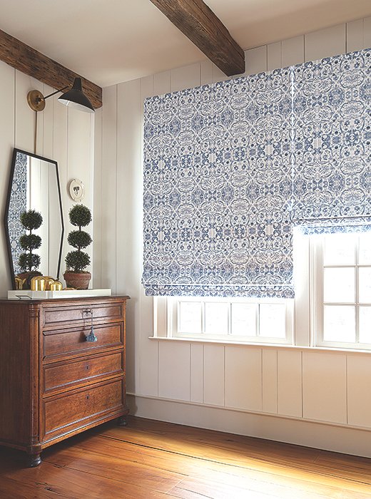 Roman shades in Kaleidoscope add a gorgeously graphic touch to a rustic farmhouse space.
