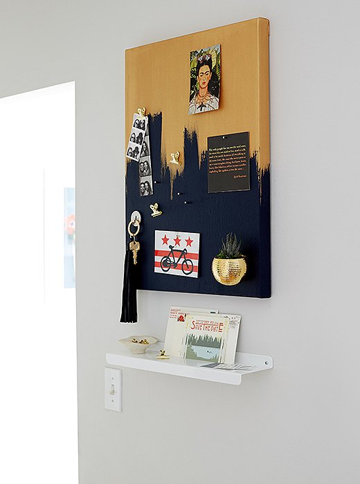 Anthony created a DIY magnetic board and a slim shelf for Ari to set her keys and hang reminders. The board also cleverly conceals the apartment’s circuit breaker.
