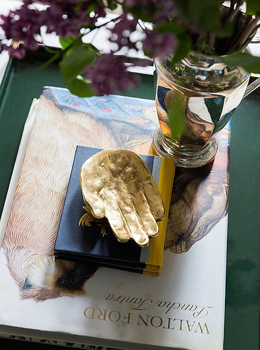 Mixed metals add luster atop the coffee table, and fresh flowers (one of CeCe’s decor musts) pick up on the touches of purple in the room.
