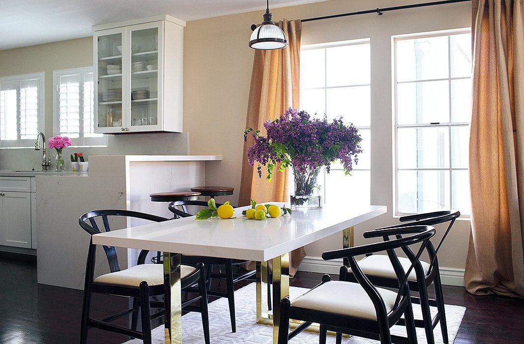 The dining area, which features a custom quartz-and-brass table and Danish chairs, is getting more use by Louise and her fiancé in a conscious effort to balance their hectic schedules. “We now do breakfast, lunch, and dinner most days,” she says. “And I think it’s important to have a place to regroup from the day and have a chat rather than collapse in front of the TV.”
