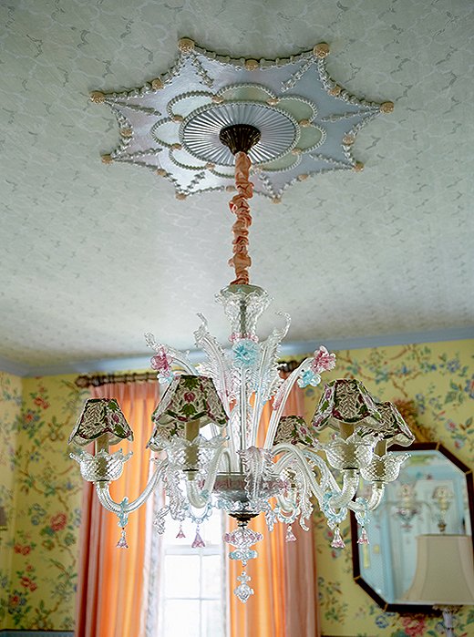 A Venetian glass chandelier with palatial appeal hangs in the dining room.
