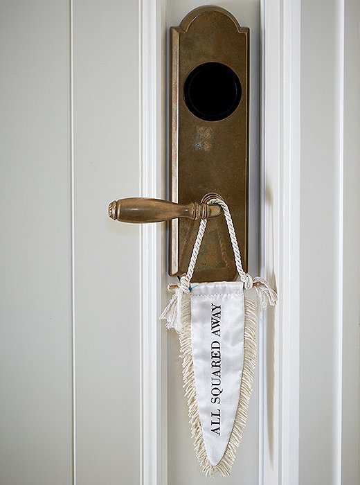 The owners worked with Cory Schifler of Urchin Workshop to design cheeky accessories for the space, including these doorknob flags—a creative take on “Please make up this room.”
