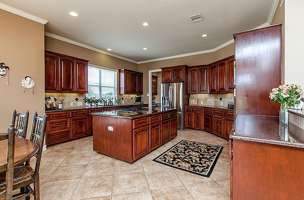 Dark cabinets and counters made the original kitchen feel closed off.
