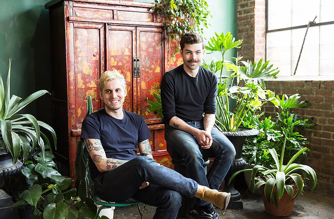 Michael (right) and Darroch Putnam, husbands and the business partners behind Putnam & Putnam, sit in their studio in front of a 350-year-old Chinese chest, given to them as a wedding present. 
