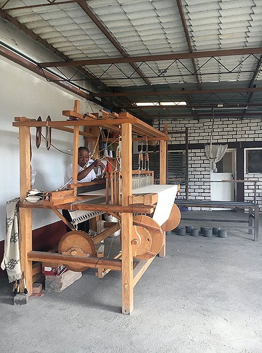 Artisans use wooden looms to weave Paradise People’s beach blankets. Photo courtesy of Paradise People.
