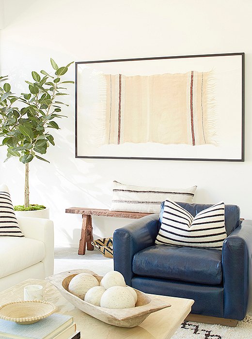 A striped Berber throw was framed as art and centered above an antique Shandong bench. 
