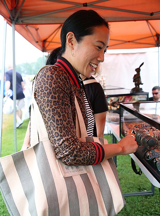 Michelle Wong surveys a case filled with vintage jewelry before buying a few silver pieces for her personal collection. Photo by Taylor Swaim.
