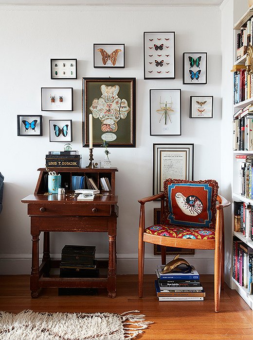 “We’re fortunate in that we’ve inherited a lot of things from our parents,” says Bobby, “so there are a lot of pieces in the apartment that have meaning for both of us.” Above, a desk from Matt’s childhood home is surrounded by butterflies and bugs from Deyrolle in Paris. A tin box, which once housed Bobby’s mother’s collection of Richard Ginori china, sits on top.
