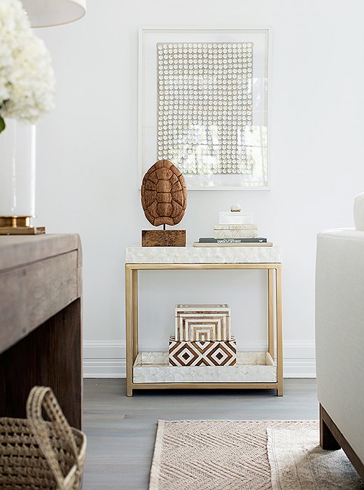 The bar cart is covered in capiz—part of the mission to add rich texture everywhere. “There’s no real color here,” Alex says, “but the capiz makes the whole spot dynamic.” And by tucking the shell and books below, Erin and Gabe can easily turn the spot into a setup for drinks when they entertain.
