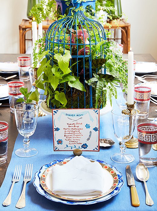 When she’s not creating custom decorative pastry sheets, Stephanie is running her other business, the Victory Club—a supper club catering to creative groups. Her hand-painted menus are a signature; she made this one to coordinate with a mix of vintage tableware found on One Kings Lane. An arrangement of tropical plants inside a blue-painted birdcage makes for a fabulous (and long-lasting) centerpiece. 
