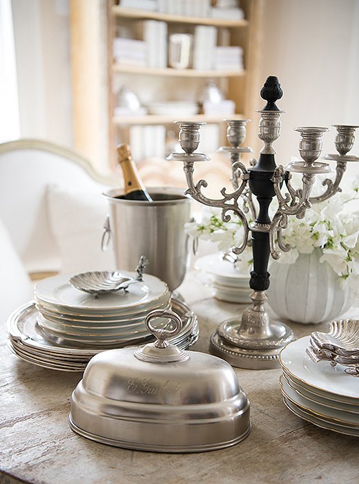 Tara relies on her collection of French antique plates for dinner parties. Bucking the current trend of eat-in kitchens, “we really do formal meals in our dining room,” Tara says, complete with place cards and multiple courses. When the meal’s finished, “we clear the table and play card games.”
