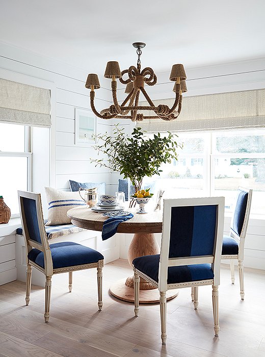 Toby and Will had a banquette installed during the renovation, a decision they feel “encourages guests to linger.” Beneath a rope-wrapped chandelier by Jamie Young, a round pedestal table and color-blocked velvet chairs provide just the right amount of comfort and formality.
