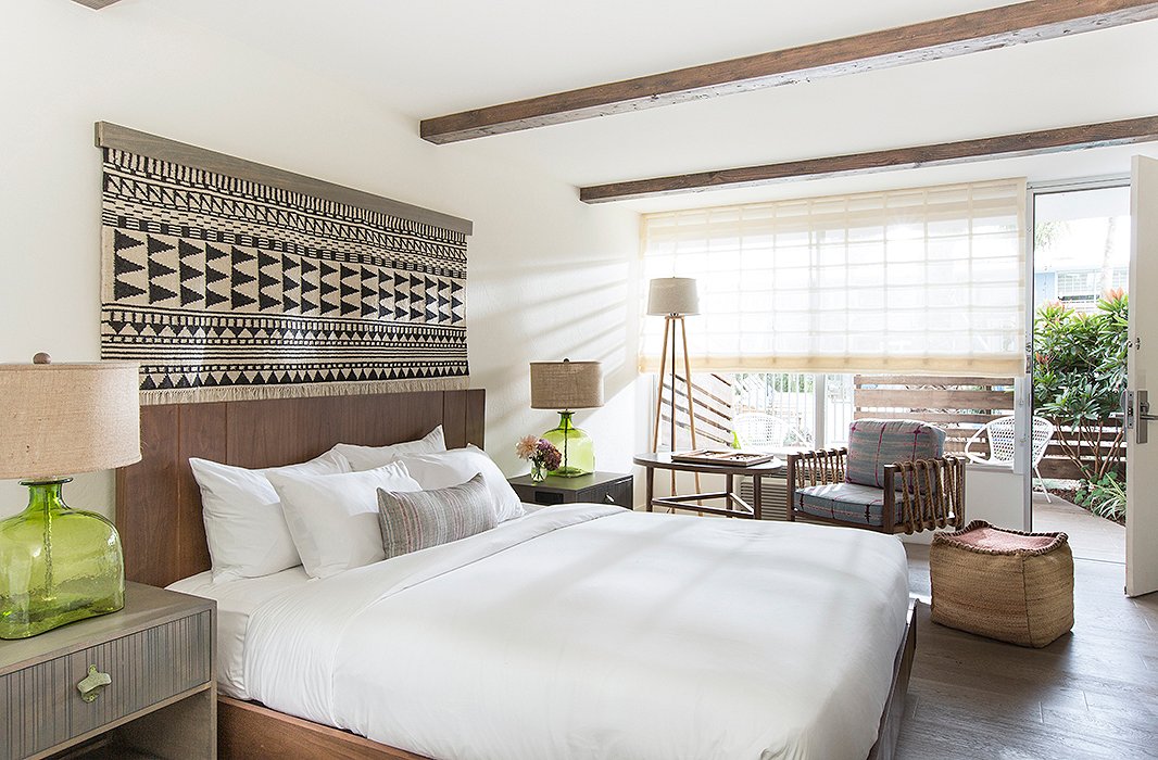 A private patio turns this bedroom into a true oasis. The Teddy Woven Cube Pouf is similar to the one above. Photo courtesy of The Goodland.
