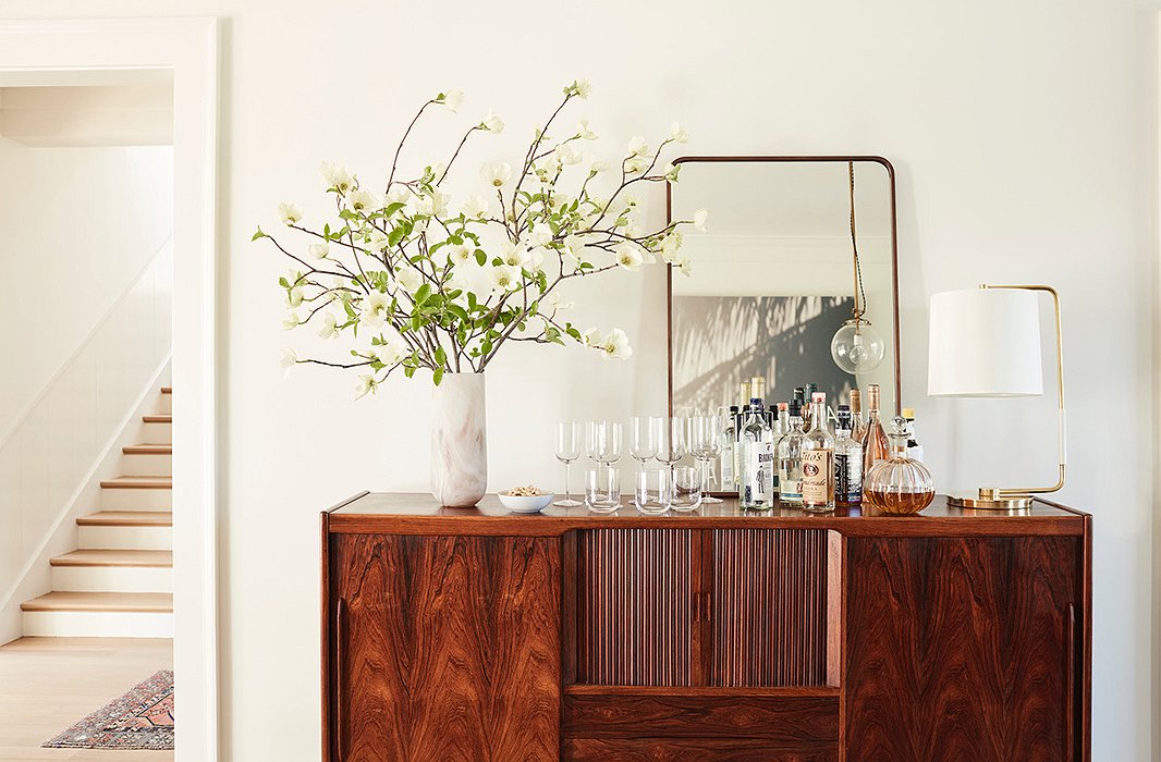 The top of Jennifer’s buffet doubles as a makeshift bar for easy access to the good stuff when friends are over.
