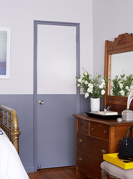 Anthony painted the closet door frames and the lower half of the walls a serene ocean blue to define the space.
