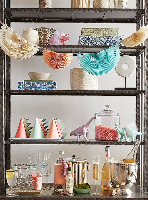 Stocked with glassware, an ice bucket, and beverages, an étagère becomes a temporary champagne bar for adults.

