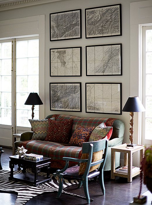 A series of framed maps brings classic polish to a cozy sitting area. Photo by Manuel Rodriguez. 
