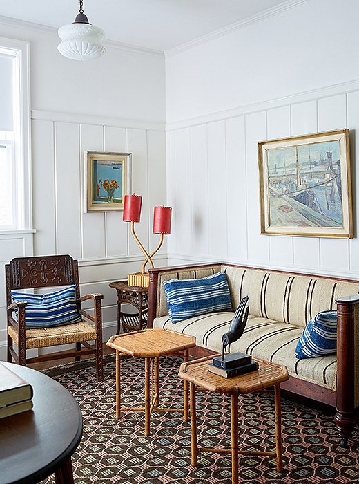 A seating area in one of the suites features an eclectic collection of antiques, including an English sofa, bamboo pieces from the South Pacific, and Nordic paintings.
