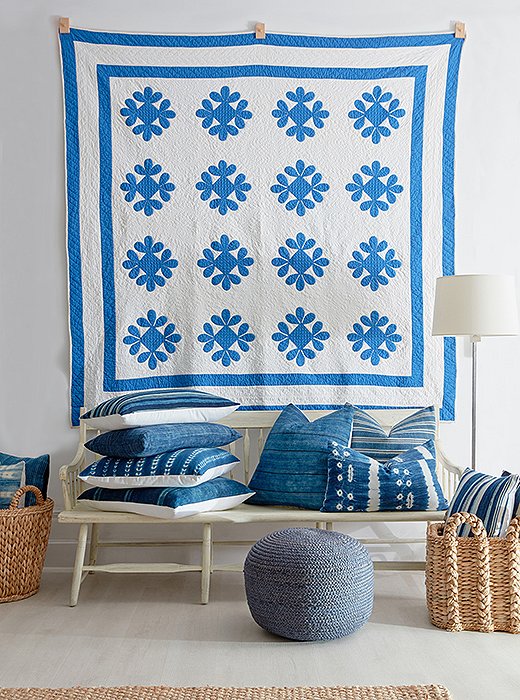 A beautifully patterned quilt can be a refreshing alternative to framed artwork. Photo by Tony Vu.
