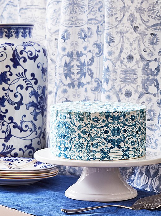 Shades by One Kings Lane for The Shade Store—featuring an exclusive abstract floral print—set off the apartment’s dramatic two-story windows. Stephanie used the pattern as inspiration for one of her signature cake sheets.  
