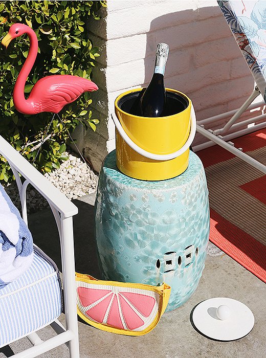 Topped with a vintage ice bucket, a garden stool makes an ideal outdoor (mini) bar.
