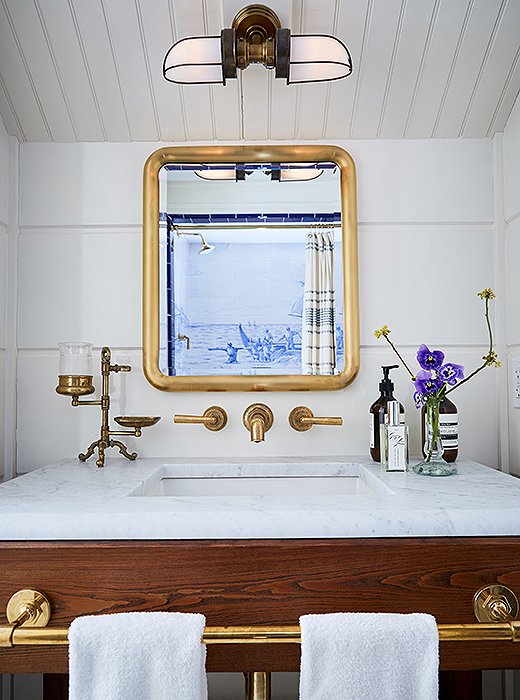 Bathrooms feature Waterworks brass fixtures, custom cabinets with honed marble countertops, and Aesop bath products.
