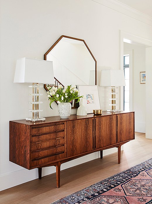 “Our favorite pieces in this house are the credenzas in the entryway and dining room,” says Louisa. “Those spaces were so specific; it was a little scary picking out vintage online. But they came in great condition and fit perfectly.” Jennifer wholeheartedly agrees: “The best part of the entryway is that vintage credenza,” she says. “I’m so in love with it.”
