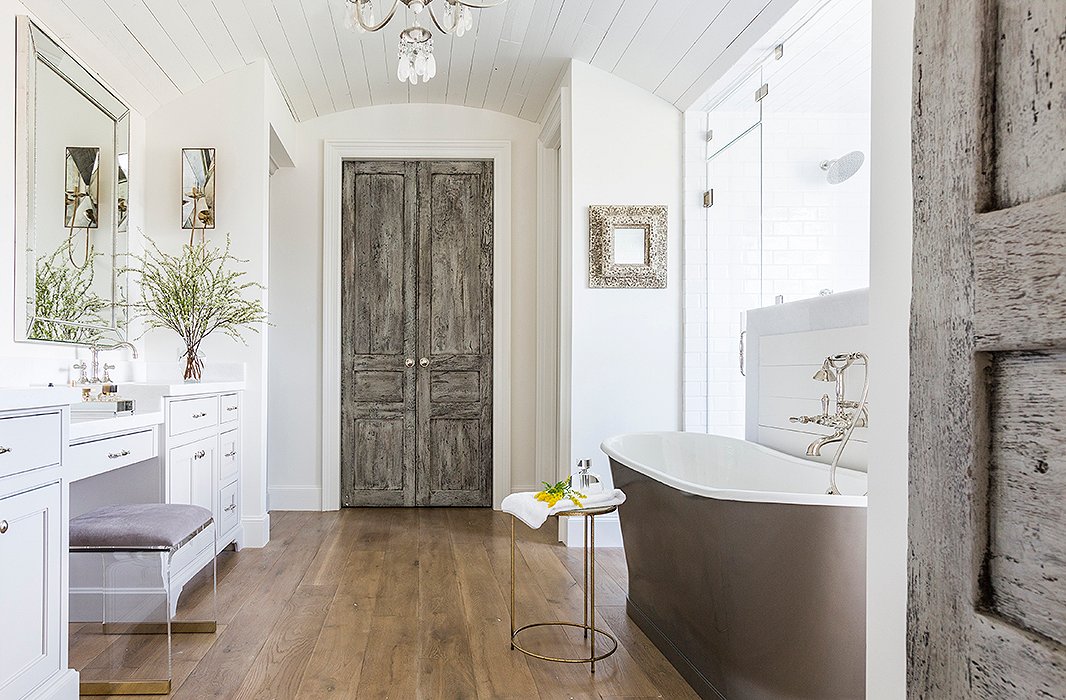 Marie’s team transformed the master bath, creating a new shower enclosure and adding a freestanding tub. Photo by Julie Soefer.
