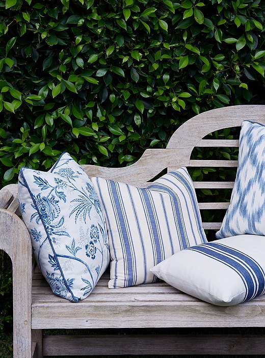 A blue-and-white palette unifies a collection of patterned pillows from Mark’s line.
