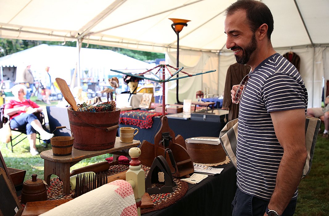 Anthony Santelli checks out a table filled with all-American antiques. Photo by Taylor Swaim.
