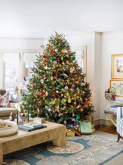 The family room tree twinkles with white lights and ornaments of every shape and size. 
