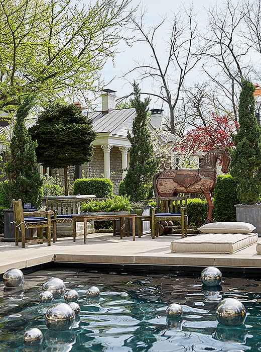 Silver orbs float in the saltwater pool behind the main house. Kept hidden by hedges and a life-size wooden horse, it’s a well-used feature on hot and humid Southern days. 
