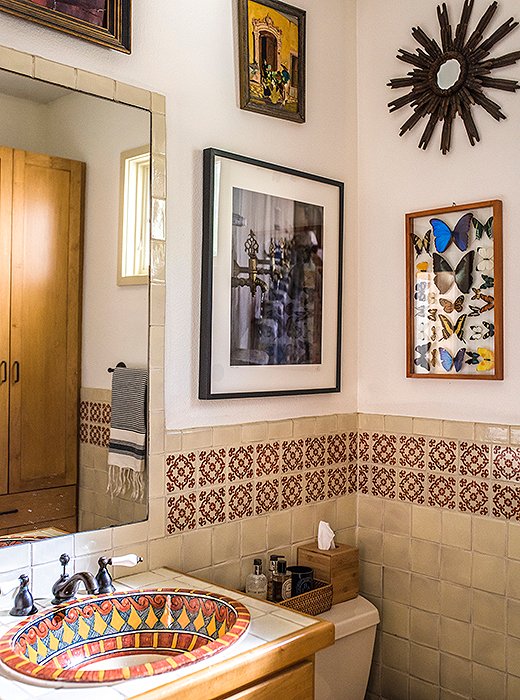 Bold tiles and bespoke fixtures are a surefire way to nail the boho look in the bathroom. Accessorize with eclectic art and texture-rich accents to finish the look. Photo by Shayna Fontana.
