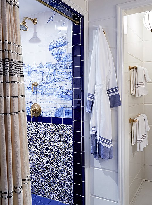 The custom nautical scenes on the bathroom tiles were hand-painted in Portugal and put together on-site like a puzzle.
