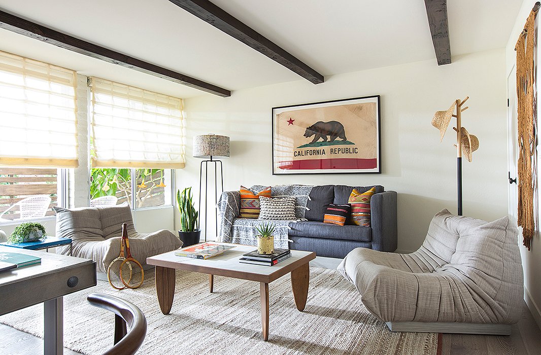 Wood beams lend architectural character to this bedroom’s sitting area. Photo courtesy of The Goodland.
