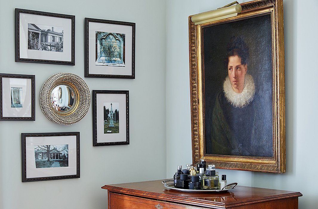 A butler’s chest from the early 19th century holds court with an old portrait of an unknown woman. Taken by Clay Lancaster, an advocate of architectural preservation, the adjacent photographs of Botherum in its most dilapidated state remind Jon and Dale of how far the home has come. 
