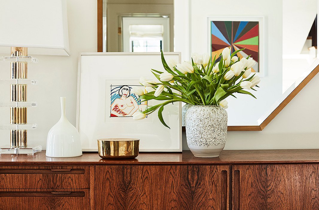 “Musts for an entryway are a credenza with storage, a superspecial lamp, a tray or bowl for keys, and a mirror to reflect the light that comes in through the front,” Emily says.
