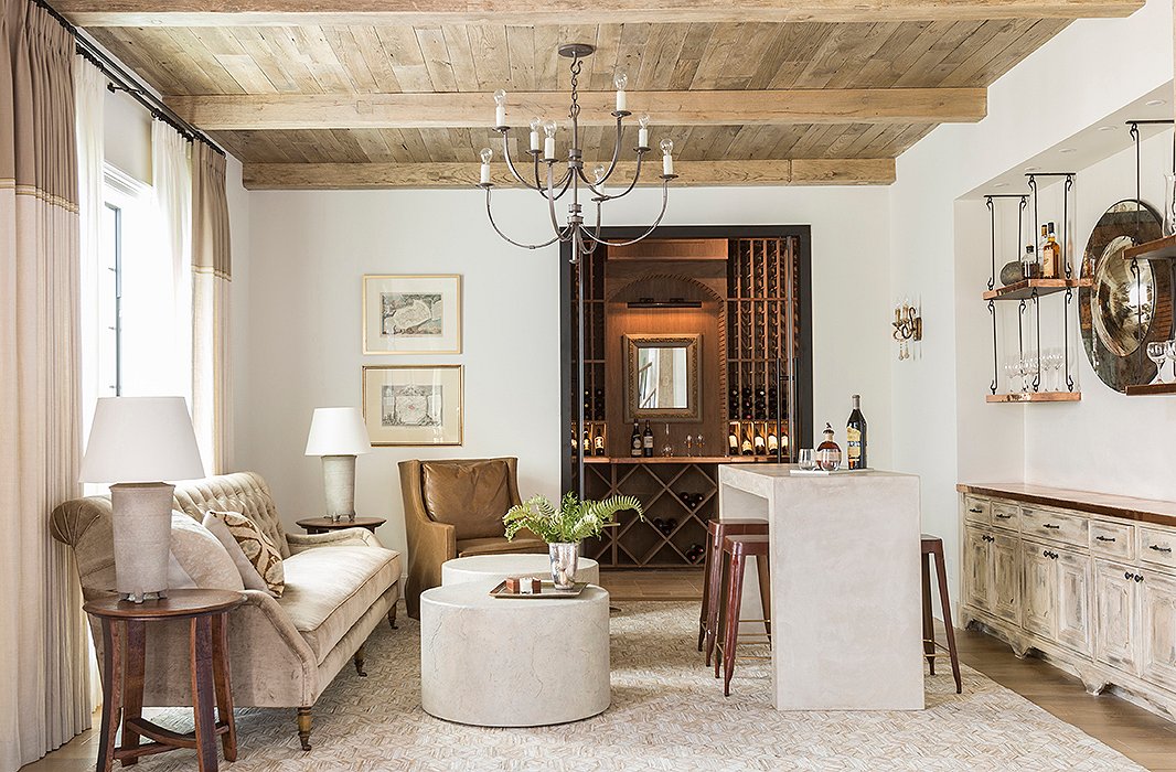 The original family room is now a sumptuous lounge that marries light-tone traditional elements and a rustic, masculine vibe. Photo by Julie Soefer.
