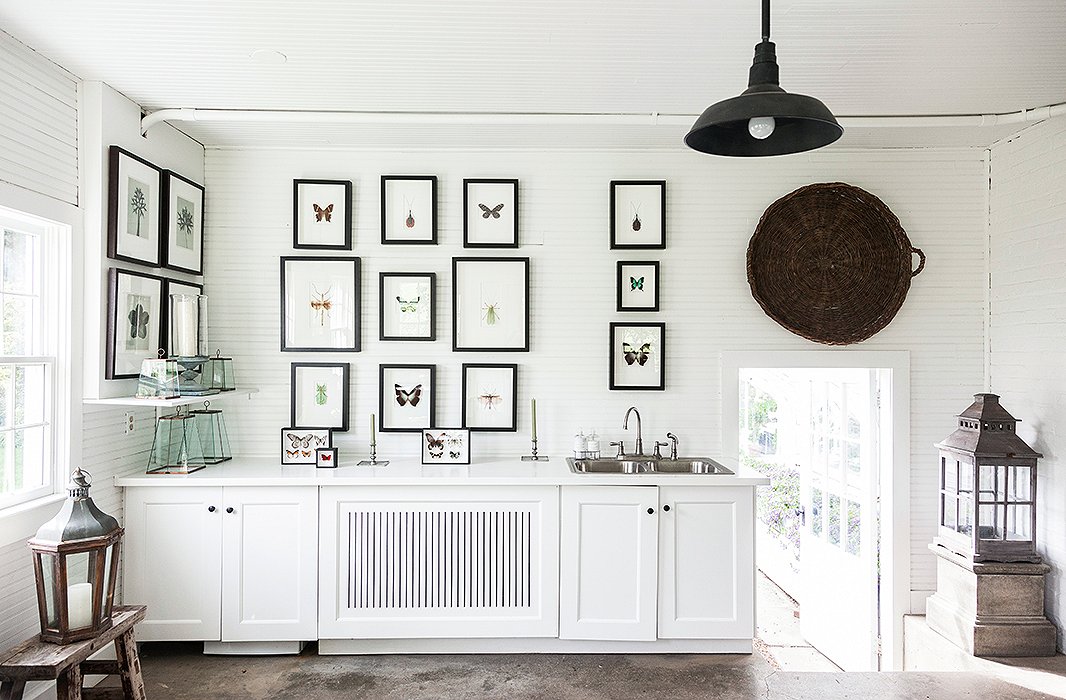 Matching black frames contrast beautifully with this room’s stark white walls and cabinetry. Photo by Lesley Unruh.
