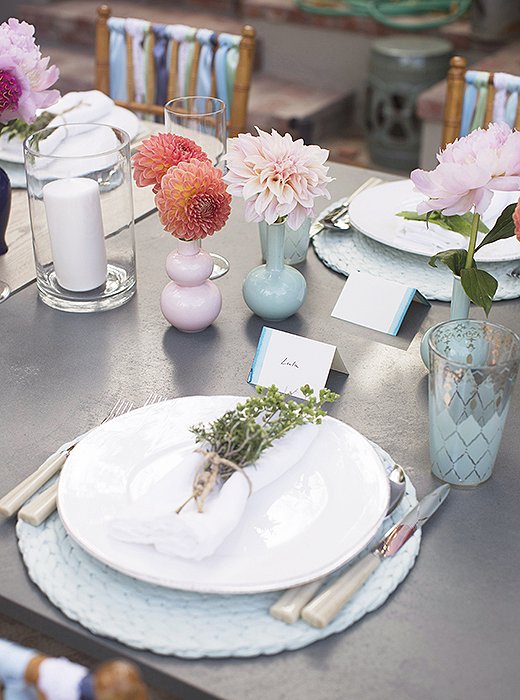 Susan arranged each place setting with Lastra dinner plates by Vietri, horn-color flatware by Sabre, and delicate mint-and-gold water glasses that were in keeping with her soft-hued palette.
