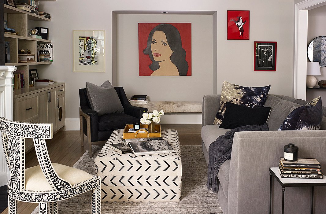 Artwork passed down from Suki’s mother, including a Warhol portrait, pops perfectly against neutral walls. Underneath, a hide-and-acrylic bench serves as the perfect spot for guests to perch. 

