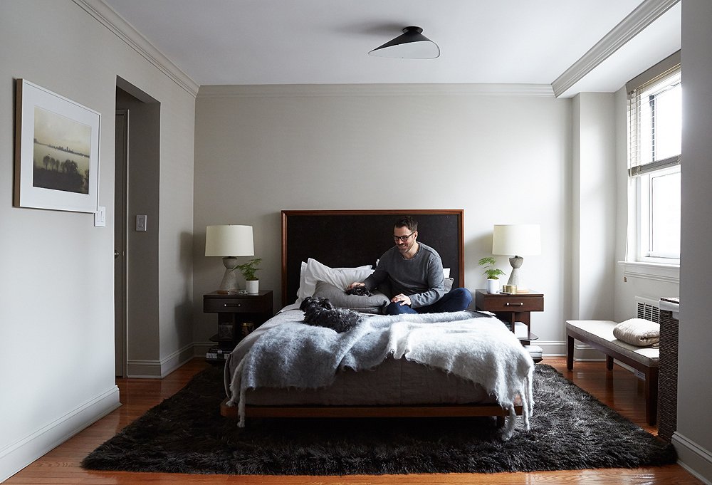 A headboard inset with black cork adds yet another textural layer to the bedroom.
