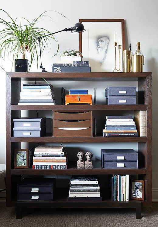 Shawn anchored the vignette on top of his bookcase with a few favorite gifts from friends, including a framed drawing and a set of Josef Frank candlesticks.
