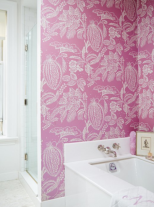 To invigorate the all-white bath, Amanda covered the walls with a Manuel Canovas paper in hot pink. “It’s sort of my little nook when I’m relaxing at the end of the day,” she says. “It’s my happy spot.”
 
