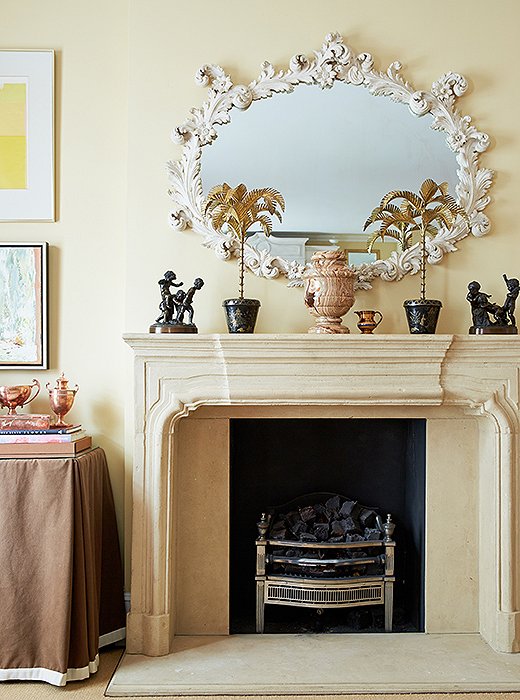An ornate oval mirror turns the mantel into a major moment. Photo by Tony Vu.
