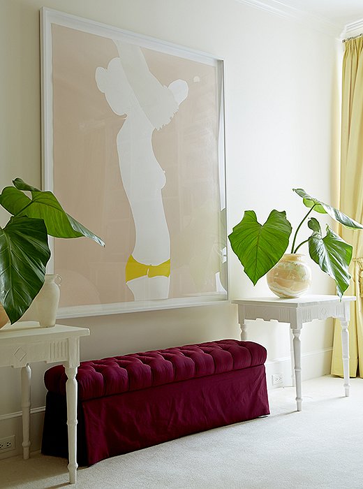 “I love the cheeky subject matter and her use of color,” says Amanda of the nude painting by Natasha Law, which presides over her bedroom above a custom-made bench and tables by Brooklyn plaster artist Stephen Antonson.
