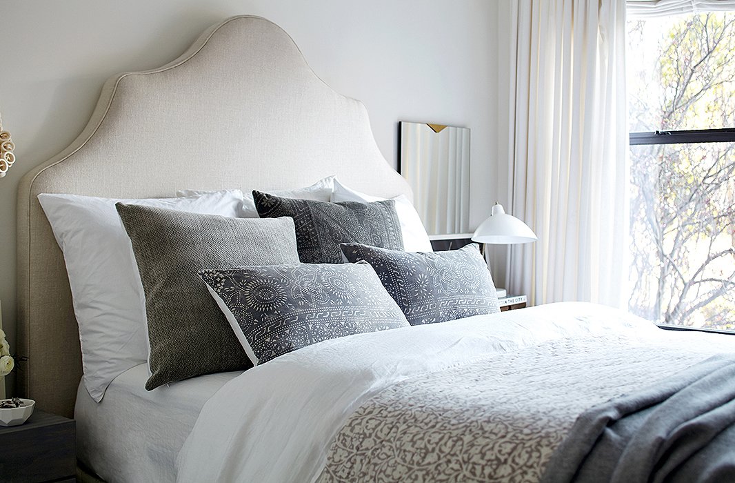 With a bedroom that’s on the small side—not much extra space for art or accent furniture—we kept the focus squarely on the bed, making it extra-luscious with bedding that looks a foot deep.
