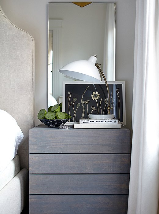 For their matching nightstands, Caitlin and her husband wanted something gender-neutral. These gray-washed nightstands hit the right note, and they offer lots of storage—something that’s hard to come by for any smaller bedroom.

